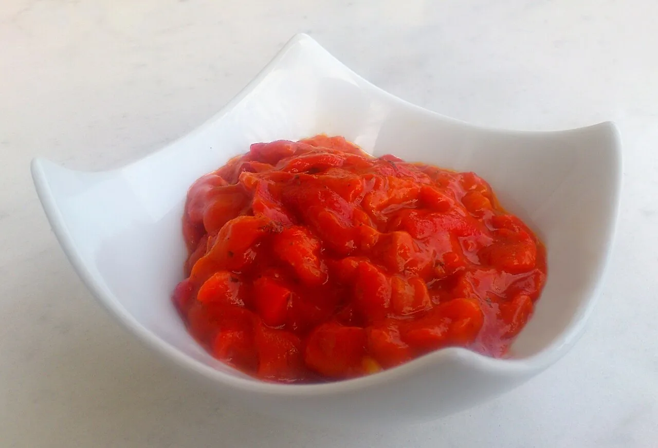 A white dish of lyutenitsa, the Bulgarian roasted red pepper and tomato relish