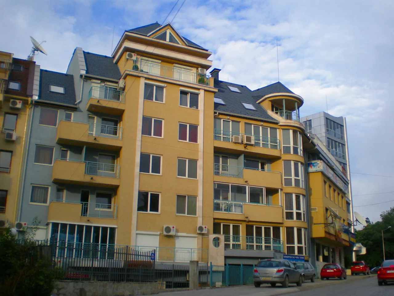 A residential street in Lozenets, Sofia, lined with balconied apartment buildings and parked cars