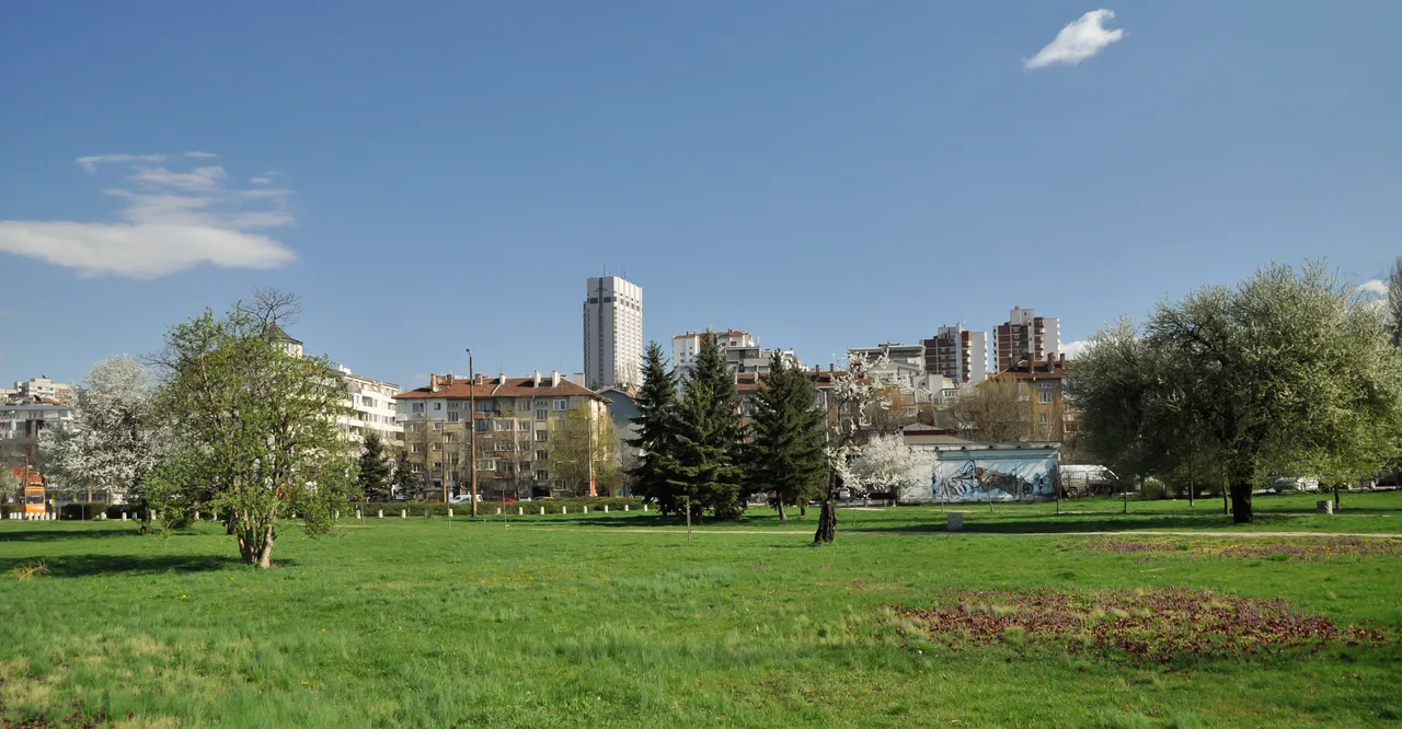 South Park in Sofia in spring, wide green lawns with the apartment blocks of Lozenets behind