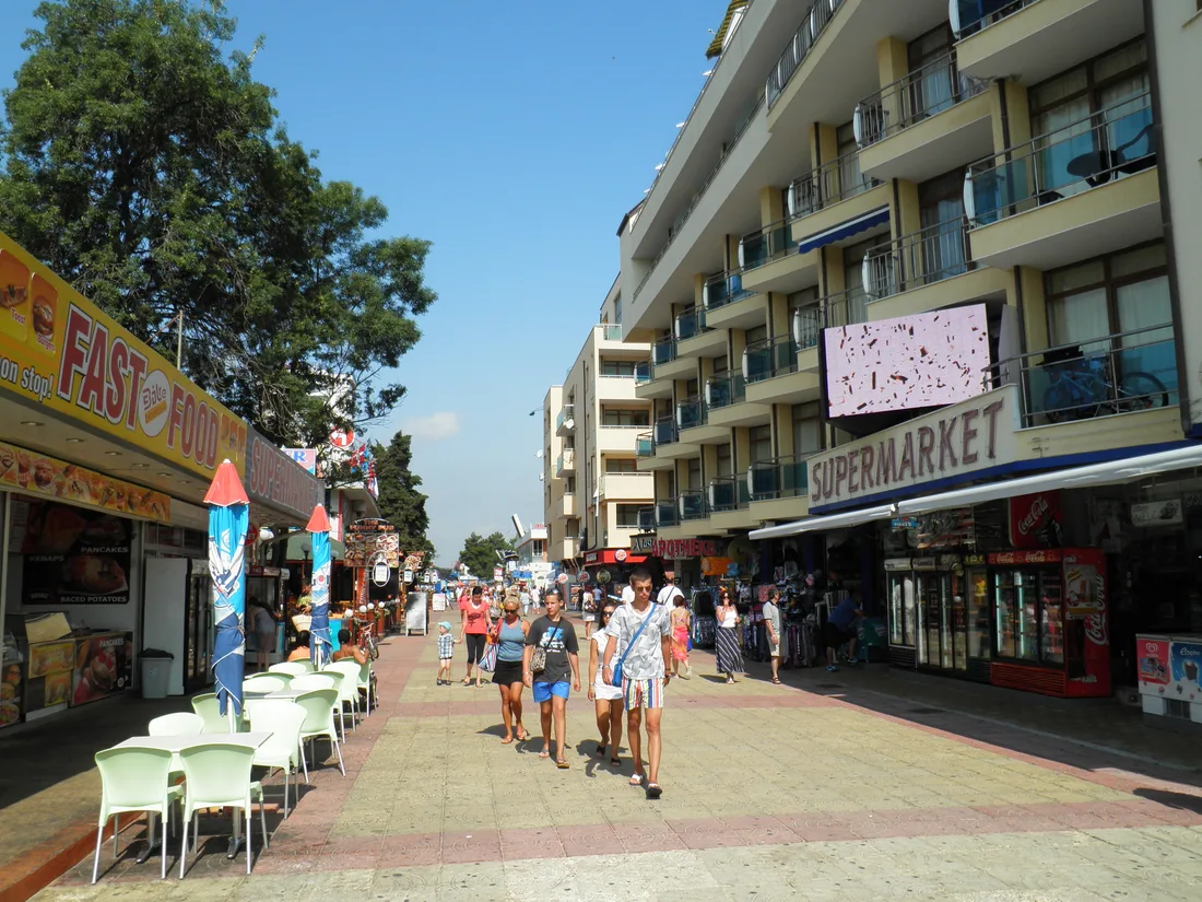 The main pedestrian strip of Sunny Beach lined with hotels, shops, a supermarket and fast-food terraces