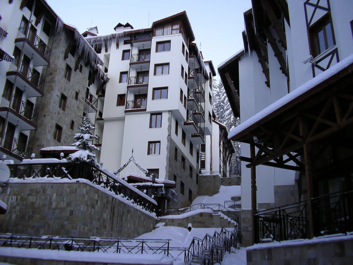 A snow-covered hotel and apartment complex with tiered balconies at the Pamporovo ski resort