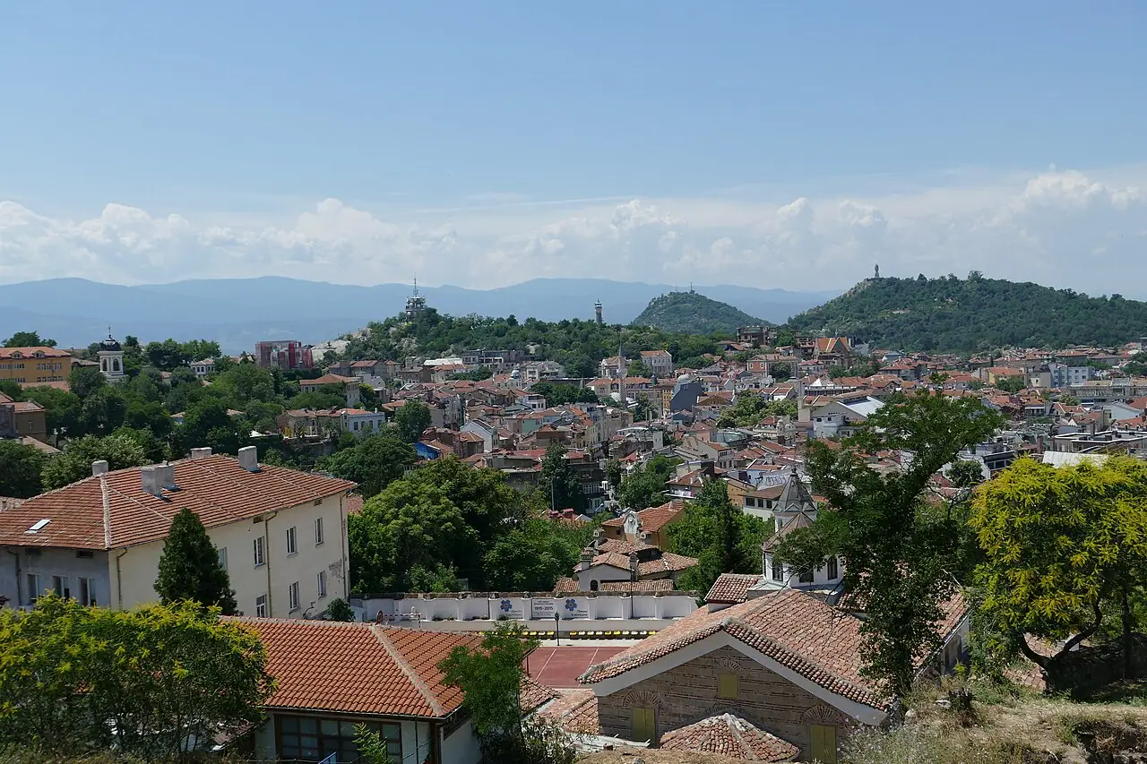 Daytime view over the terracotta rooftops of Plovdiv Old Town toward the surrounding hills