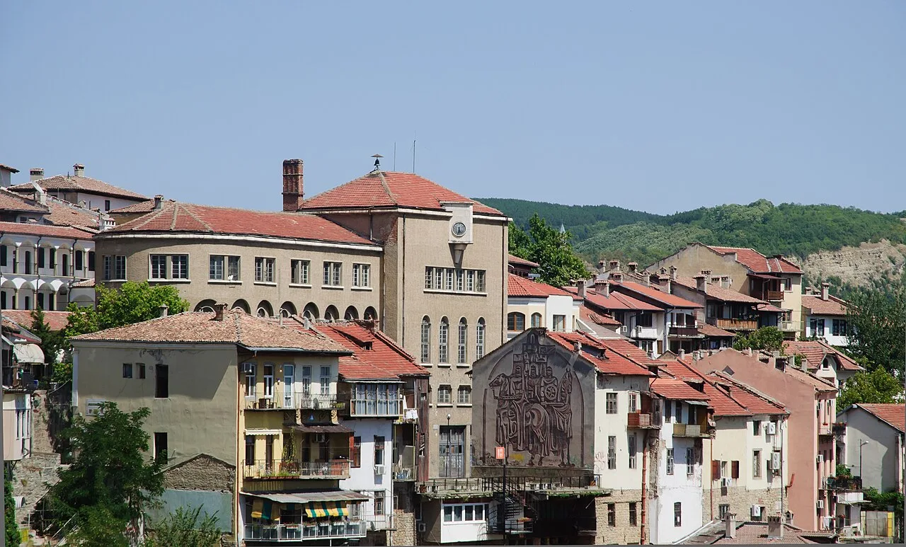 Ochre and white houses of Veliko Tarnovo old town clinging to the steep slope above the Yantra