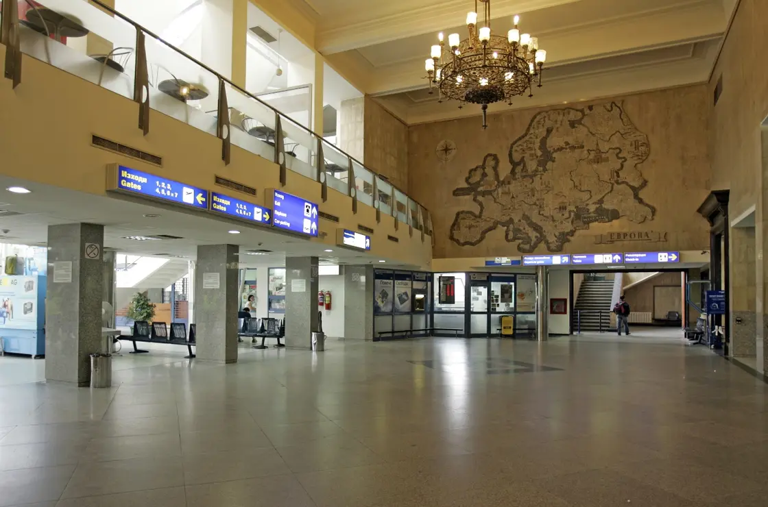 Inside Terminal 1 at Sofia Airport, showing the check-in area and a low ceiling with passengers and luggage