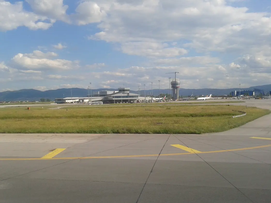 The exterior of Terminal 2 at Sofia Airport with its curved glass frontage and the control tower behind