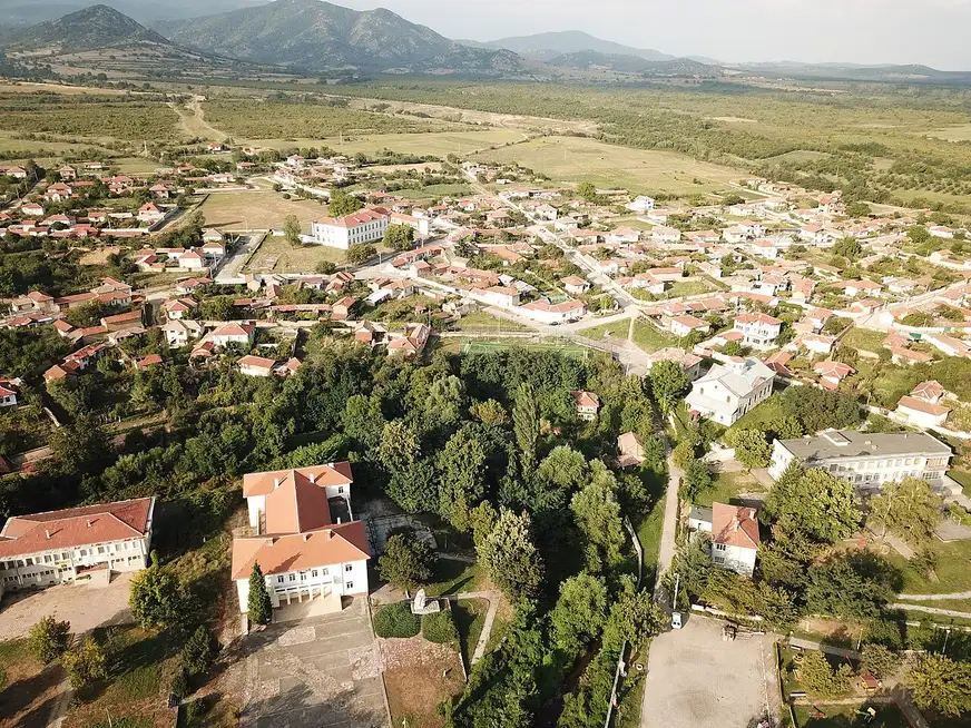 The village of Starosel from above, red roofs among fields at the foot of the Sredna Gora hills